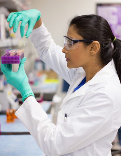 Closeup,Portrait,,Young,Scientist,In,Labcoat,Wearing,Nitrile,Gloves,,Doing